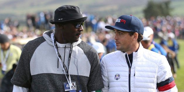 Basketball legend Michael Jordan walks up to the 12th green with Keegan Bradley, right, of the US during the fourball match on the second day of the Ryder Cup golf tournament at Gleneagles, Scotland, Saturday, Sept. 27, 2014. (AP Photo/Peter Morrison)