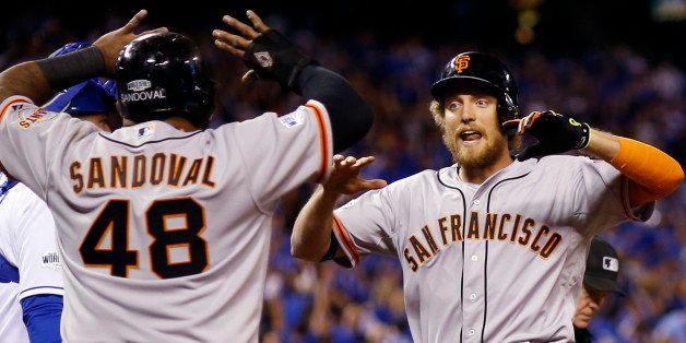 San Francisco Giants' Hunter Pence is congratulated by Pablo Sandoval after Pence hit a two-run home run during the first inning of Game 1 of baseball's World Series against the Kansas City Royals Tuesday, Oct. 21, 2014, in Kansas City, Mo. (AP Photo/David J. Phillip)