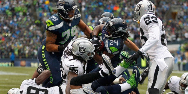 SEATTLE, WA - NOVEMBER 02: Running back Marshawn Lynch #24 of the Seattle Seahawks bulls his way into the end zone for a touchdown during the first quarter of the game against the Oakland Raiders at CenturyLink Field on November 2, 2014 in Seattle, Washington. (Photo by Otto Greule Jr/Getty Images)