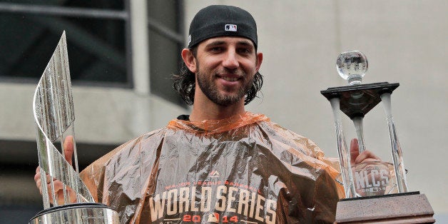 San Francisco Giants baseball player and World Series MVP Madison Bumgarner holds the MVP trophies during the victory parade for the 2014 World Series baseball champions on Friday, Oct. 31, 2014, in San Francisco. (AP Photo/Marcio Jose Sanchez)