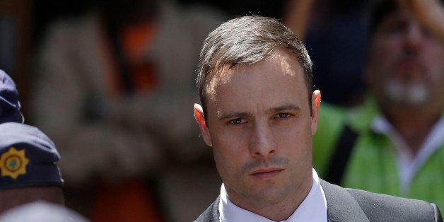 FILE - In this Friday, Oct. 17, 2014 file photo, Oscar Pistorius is escorted by police officers as he leaves the high court in Pretoria, South Africa. A spokesman for South Africa's National Prosecuting Authority said Monday, Oct. 27, 2014 that prosecutors will appeal the verdict and sentencing of Oscar Pistorius, who was handed a 5-year prison term after being convicted of culpable homicide. (AP Photo/Themba Hadebe, File)