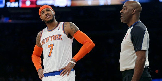New York Knicks' Carmelo Anthony (7) argues a call with referee Haywoode Workman during the first half of an NBA basketball g