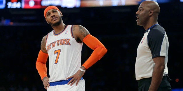 New York Knicks' Carmelo Anthony (7) argues a call with referee Haywoode Workman during the first half of an NBA basketball game, Friday, Jan. 17, 2014, in New York. (AP Photo/Frank Franklin II)