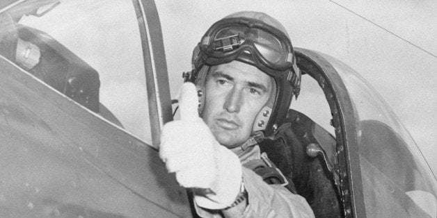 Ted Williams flashes the pilot's traditional thumb-up sign of okay to his mechanic while taking his attack aviation refresher training in a Corsair Fighter plane at Cherry Point, NC, September 4, 1952. (AP Photo)