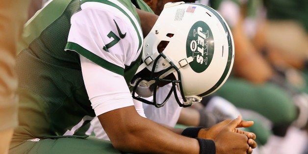 EAST RUTHERFORD, NJ - OCTOBER 26: Quarterback Geno Smith #7 of the New York Jets reactrs on the bench in the fourth quarter