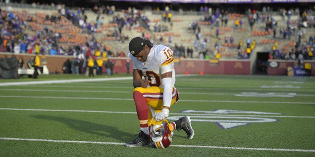 MINNEAPOLIS MN, NOVEMBER 2: Washington quarterback Robert Griffin III (10) kneels to pray as he leaves the field after the Minnesota Vikings defeat the Washington Redskins 29 - 26 in Minneapolis MN, November 2, 2014 (Photo by John McDonnell/The Washington Post via Getty Images)