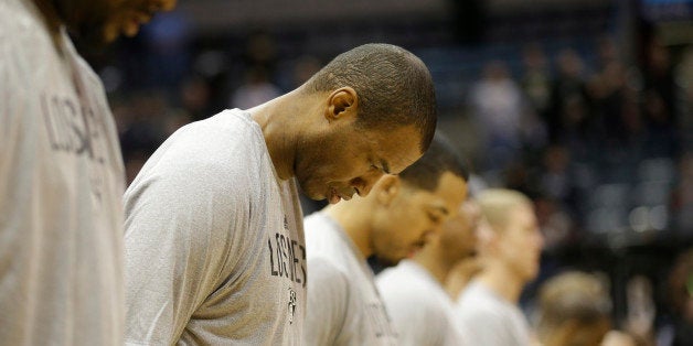 Brooklyn Nets' Jason Collins, second from left, during the national anthem before an NBA basketball game against the Milwaukee Bucks Saturday, March 1, 2014, in Milwaukee. (AP Photo/Jeffrey Phelps)