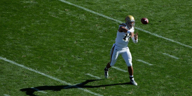 BOULDER, CO - OCTOBER 25: Quarterback Brett Hundley #17 of the UCLA Bruins throws a pass during the third quarter against the Colorado Buffaloes at Folsom Field on October 25, 2014 in Boulder, Colorado. The Bruins defeated the Buffaloes 40-37 in double overtime. (Photo by Justin Edmonds/Getty Images)