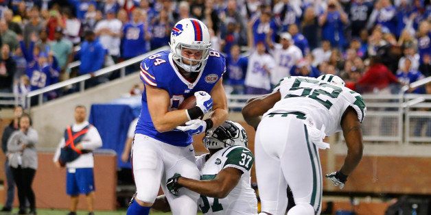DETROIT, MI - NOVEMBER 24: Scott Chandler #84 of the Buffalo Bills scores on a nineteen yard second quarter touchdown as Jaiquawn Jarrett #37 of the New York Jets defends during the game at Ford Field on November 24 , 2014 in Detroit, Michigan. (Photo by Leon Halip/Getty Images)