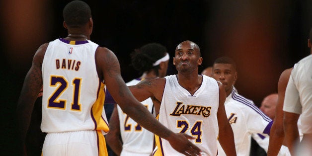 LOS ANGELES, CA - NOVEMBER 23: Kobe Bryant #24 of the Los Angeles Lakers celebrates with teammate Ed Davis #21 during the fi