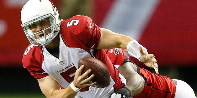 Atlanta Falcons defensive end Jonathan Babineaux hits Arizona Cardinals quarterback Drew Stanton (5) during the first half of an NFL football game, Sunday, Nov. 30, 2014, in Atlanta. (AP Photo/John Bazemore)