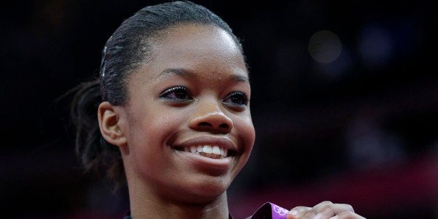 U.S. gymnast Gabrielle Douglas displays her gold medal during the artistic gymnastics women's individual all-around competition at the 2012 Summer Olympics, Thursday, Aug. 2, 2012, in London. (AP Photo/Julie Jacobson)