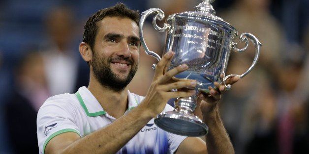 Marin Cilic, of Croatia, hoists the trophy after defeating Kei Nishikori, of Japan, during the championship match of the 2014 U.S. Open tennis tournament, Monday, Sept. 8, 2014, in New York. (AP Photo/Charles Krupa)