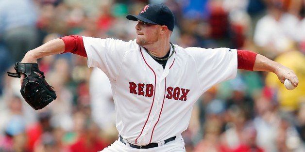 Boston Red Sox's Jon Lester pitches during the first inning of a baseball game against the Kansas City Royals in Boston, Sunday, July 20, 2014. (AP Photo/Michael Dwyer)