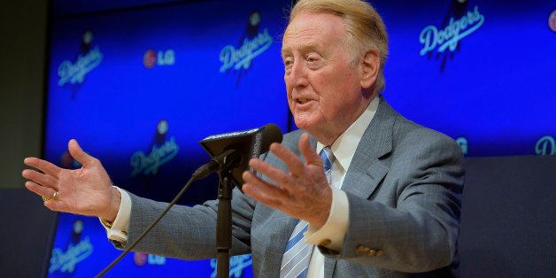 Los Angeles Dodgers announcer Vin Scully speaks to the media prior to a baseball game against the Atlanta Braves, Wednesday, July 30, 2014, in Los Angeles. The 86-year-old Hall of Fame announcer said Tuesday that he will return for his record 66th season with the team in 2015. (AP Photo/Mark J. Terrill)