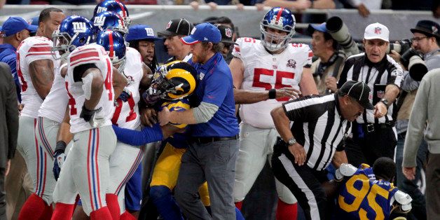 Members of the St. Louis Rams and the New York Giants fight on the sideline during the first half of an NFL football game Sunday, Dec. 21, 2014, in St. Louis. Members of both teams were ejected after the altercation. (AP Photo/Tom Gannam)