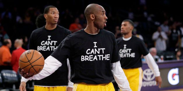 Los Angeles Lakers' Kobe Bryant, center, and his teammates warm up before an NBA basketball game against the Sacramento Kings, Tuesday, Dec. 9, 2014, in Los Angeles. Several athletes have worn "I Can't Breathe" shirts during warm ups in support of the family of Eric Garner, who died July 17 after a police officer placed him in a chokehold when he was being arrested for selling loose, untaxed cigarettes. (AP Photo/Jae C. Hong)