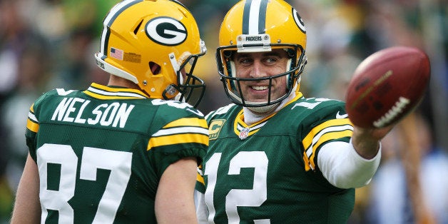 GREEN BAY, WI - DECEMBER 28: Aaron Rodgers #12 of the Green Bay Packers reacts in the first quarter against the Detroit Lions at Lambeau Field on December 28, 2014 in Green Bay, Wisconsin. (Photo by Chris Graythen/Getty Images)