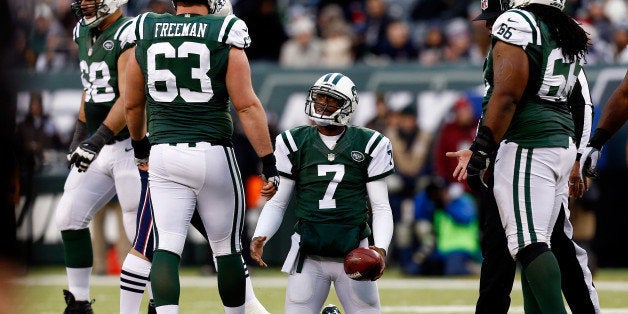 EAST RUTHERFORD, NJ - DECEMBER 21: Quarterback Geno Smith #7 of the New York Jets reacts against the New England Patriots dur