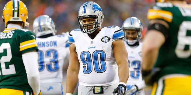 GREEN BAY, WI - DECEMBER 28: Ndamukong Suh #90 of the Detroit Lions talks with quarterback Aaron Rogers #12 of the Green Bay Packers during the second quarter of the game at Lambeau Field on December 28, 2014 in Green Bay, Wisconsin. The Packers defeated the Lions 30-20. (Photo by Leon Halip/Getty Images)