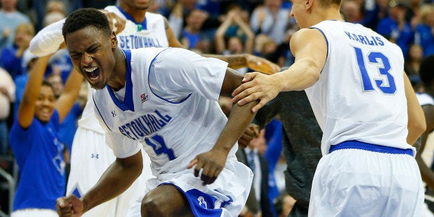 NEWARK, NJ - JANUARY 3: Sterling Gibbs #4, Brandon Mobley #2 and Haralds Karlis #13 of Seton Hall celebrate after defeating Villanova 66-61 in overtime during an NCAA college basketball game on January 3, 2015 at the Prudential Center in Newark, New Jersey. (Photo by Rich Schultz /Getty Images)