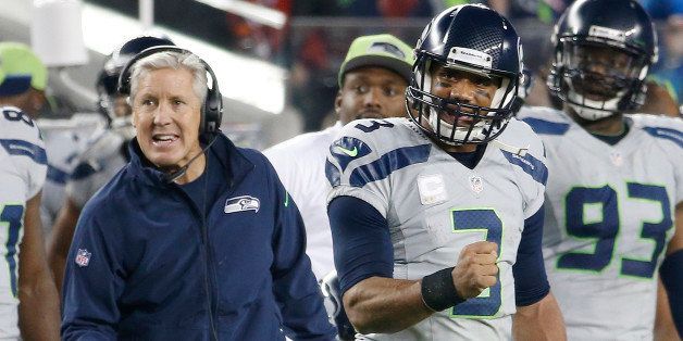 Seattle Seahawks head coach Pete Carroll, left, and quarterback Russell Wilson (3) celebrate during the fourth quarter of an NFL football game against the San Francisco 49ers in Santa Clara, Calif., Thursday, Nov. 27, 2014. (AP Photo/Tony Avelar)