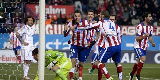 Uruguayan defender Jose Gimenez (24) celebrates after scoring during the Spanish Copa del Rey (King's Cup) round of 16 first leg football match Club Atletico de Madrid vs Real Madrid CF at the Vicente Calderon stadium in Madrid on January 7, 2015. AFP PHOTO/ DANI POZO (Photo credit should read DANI POZO/AFP/Getty Images)