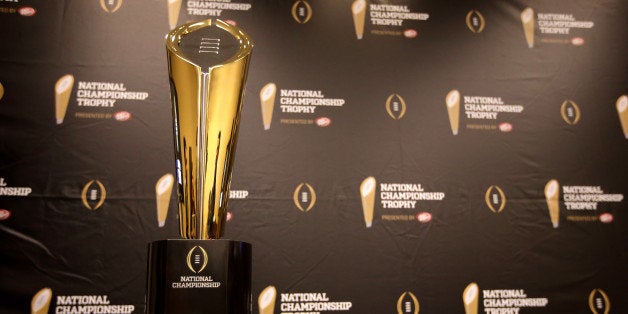 This Monday, July 14, 2014 photo shows the College Football Playoff National Championship Trophy in Irving, Texas. A rising gold football-shaped trophy will be the prize for the national champion in the new College Football Playoff. (AP Photo/Tony Gutierrez)