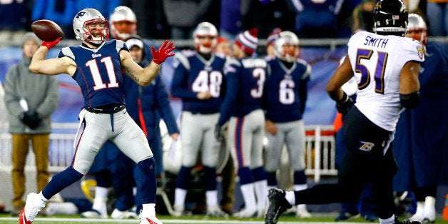 FOXBORO, MA - JANUARY 10: Julian Edelman #11 of the New England Patriots throws a touchdown pass on a flea flicker play during the second half of the 2015 AFC Divisional Playoffs game against the Baltimore Ravens at Gillette Stadium on January 10, 2015 in Foxboro, Massachusetts. (Photo by Jared Wickerham/Getty Images)