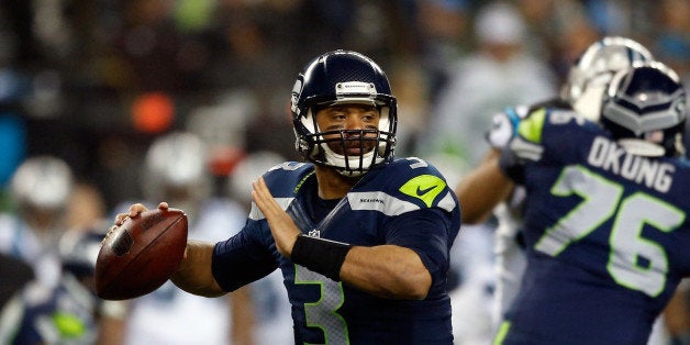 SEATTLE, WA - JANUARY 10: Russell Wilson #3 of the Seattle Seahawks throws the ball in the first half against the Carolina Panthers during the 2015 NFC Divisional Playoff game at CenturyLink Field on January 10, 2015 in Seattle, Washington. (Photo by Otto Greule Jr/Getty Images)