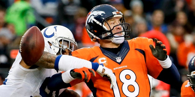 Indianapolis Colts linebacker Jonathan Newsome, left, reaches in to force Denver Broncos quarterback Peyton Manning fumble during the first half of an NFL divisional playoff football game, Sunday, Jan. 11, 2015, in Denver. (AP Photo/Jack Dempsey)