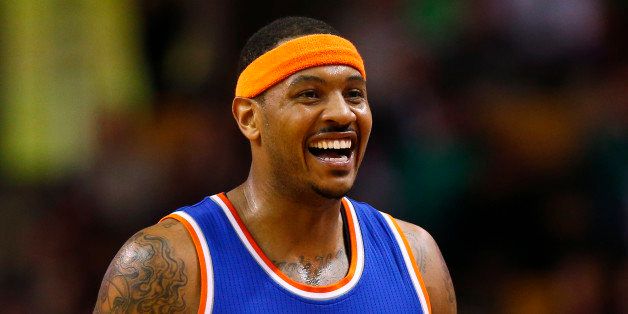 New York Knicks' Carmelo Anthony smiles during the second half of the New York Knicks 101-95 win over the Boston Celtics in an NBA basketball game in Boston Friday, Dec. 12, 2014. (AP Photo/Winslow Townson)