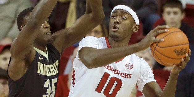 Arkansas' Bobby Portis (10) tries to pass around Vanderbilt's James Siakam (35), of Cameroon, in the first half of an NCAA college basketball game in Fayetteville, Ark., Saturday, Jan. 10, 2015. (AP Photo/Danny Johnston)