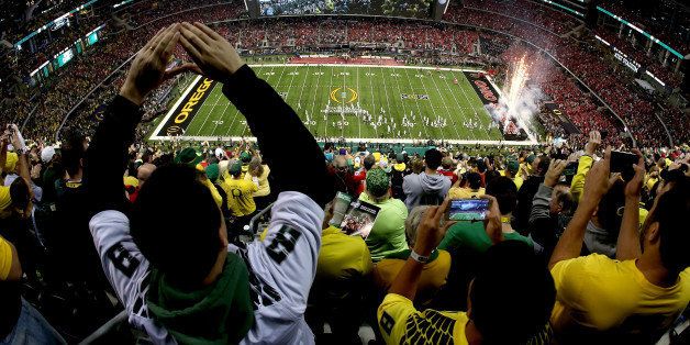 ARLINGTON, TX - JANUARY 12: Fans cheer as the Oregon Ducks take the field prior to the College Football Playoff National Championship Game against the Ohio State Buckeyes at AT&T Stadium on January 12, 2015 in Arlington, Texas. (Photo by Sarah Glenn/Getty Images)