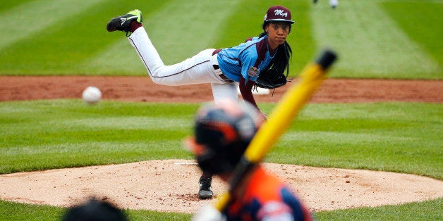 FILE - In this Aug. 15, 2014, file photo, Philadelphia's Mo'ne Davis delivers in the first inning against Nashville's Robert Hassell III during a baseball game in U.S. pool play at the Little League World Series tournament in South Williamsport, Pa. Davis, who became an instant celebrity in August when she became the first girl to win a Little League World Series game, is The Associated Press 2014 Female Athlete of the Year. (AP Photo/Gene J. Puskar, File)