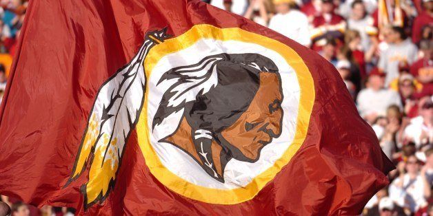 LANDOVER, MD - OCTOBER 15: The Washington Redskins flag is waved against the Tennessee Titans at FedExField on October 15, 2006 in Landover, Maryland. The Titans defeated the Redskins 25-22. (Photo by Larry French/Getty Images)