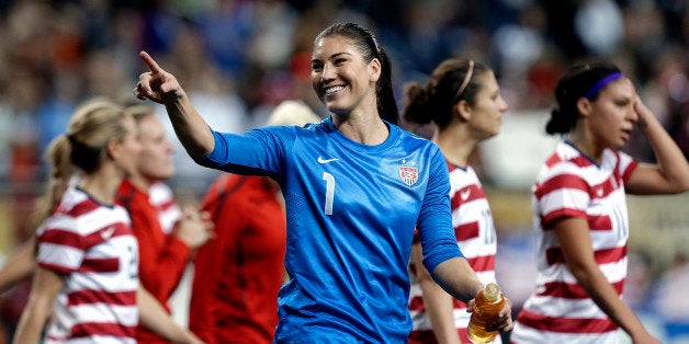 United State's Hope Solo (1) points the crowd after defeating China 2-0 in an international friendly soccer match at Ford Field in Detroit, Saturday, Dec. 8, 2012. (AP Photo/Paul Sancya)