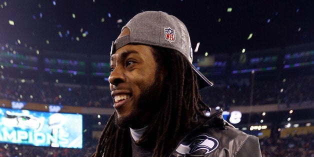 EAST RUTHERFORD, NJ - FEBRUARY 02: Cornerback Richard Sherman #25 of the Seattle Seahawks uses crutches as he walks across the field in celebration of their 43-8 victory over the Denver Broncos during Super Bowl XLVIII at MetLife Stadium on February 2, 2014 in East Rutherford, New Jersey. (Photo by Jeff Gross/Getty Images)