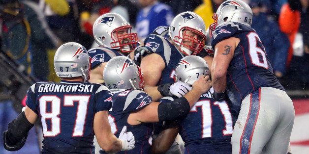 FOXBORO, MA - JANUARY 18: Nate Solder #77 of the New England Patriots celebrates a touchdown with teammates in the second half against the Indianapolis Colts of the 2015 AFC Championship Game at Gillette Stadium on January 18, 2015 in Foxboro, Massachusetts. (Photo by Jim Rogash/Getty Images)
