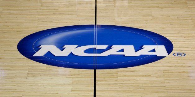 The NCAA logo is shown at half court during practice for second-round games of the NCAA college basketball tournament at The Palace in Auburn Hills, Mich., Wednesday, March 20, 2013. (AP Photo/Paul Sancya)