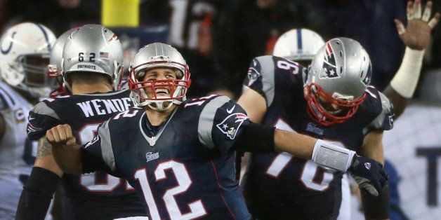 FOXBOROUGH, MA - JANUARY 18: Patriots quarterback Brady celebrates Blount's touchdown in 3rd quarter action during the AFC Championship Game at Gillette Stadium in Foxborough, Mass. on January 18, 2015. (Photo by Stan Grossfeld/The Boston Globe via Getty Images)