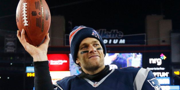 New England Patriots quarterback Tom Brady holds up the game ball after an NFL divisional playoff football game against the Baltimore RavensSaturday, Jan. 10, 2015, in Foxborough, Mass. The Patriots won 35-31 to advance to the AFC Championship game. (AP Photo/Elise Amendola)