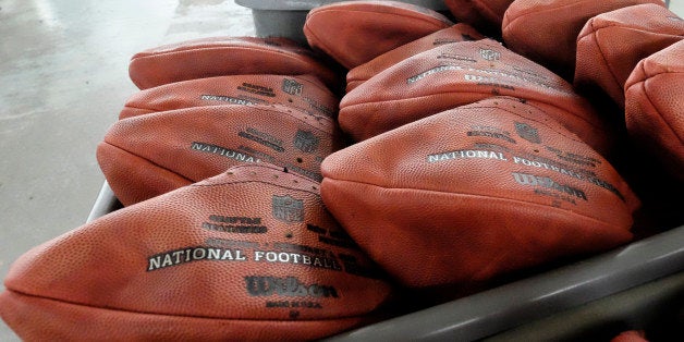 Official game balls for NFL football's Super Bowl XLIX sit in a bin before being laced and inflated at the Wilson Sporting Goods Co. in Ada, Ohio, Tuesday, Jan. 20, 2015. The New England Patriots will play the Seattle Seahawks for the NFL championship on Sunday, Feb. 1, 2015, in Glendale, Ariz. (AP Photo/Rick Osentoski)