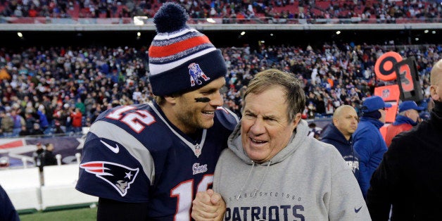 New England Patriots quarterback Tom Brady, left, celebrates with head coach Bill Belichick after defeating the Miami Dolphin