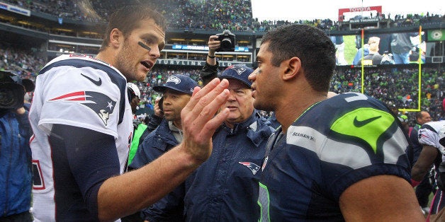 SEATTLE - OCTOBER 14: Patriots quarterback Tom Brady, left, has a word and a pat for Seattle quarterback Russell Wilson, right, following the Seahawks' 24-23 victory over New England. The New England Patriots visited the Seattle Seahawks in an NFL regular season game at CenturyLink Field. (Photo by Jim Davis/The Boston Globe via Getty Images)