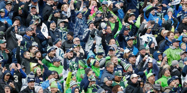 SEATTLE, WA - JANUARY 18: Fans of the Seattle Seahawks cheer during the 2015 NFC Championship game against the Green Bay Packers at CenturyLink Field on January 18, 2015 in Seattle, Washington. The Seahawks defeated the Packers 28-22 in overtime. (Photo by Christian Petersen/Getty Images)