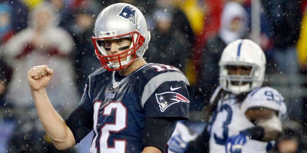 New England Patriots quarterback Tom Brady (12) celebrates LeGarrette Blount's touchdown during the second half of the NFL football AFC Championship game against the Indianapolis Colts Sunday, Jan. 18, 2015, in Foxborough, Mass. (AP Photo/Elise Amendola)