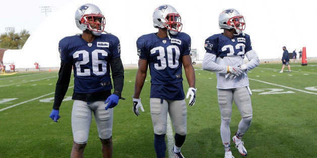 New England Patriots cornerback Logan Ryan (26), safety Duron Harmon (30) and safety Devin McCourty (32) walk to the sideline