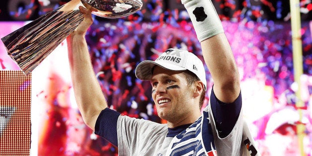 GLENDALE, AZ - FEBRUARY 01: Tom Brady #12 of the New England Patriots celebrates with the Vince Lombardi Trophy after defeat