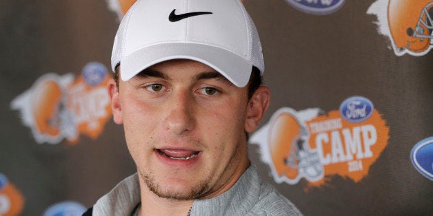 Cleveland Browns quarterback Johnny Manziel talks to reporters on the eve of the first practice at the NFL football team's training camp in Berea, Ohio, Friday, July 25, 2014. (AP Photo)